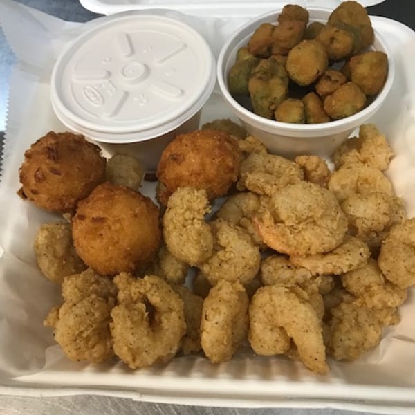 Fried shrimp, hushpuppies, and fried okra in a white takeout container from David's Catfish House.