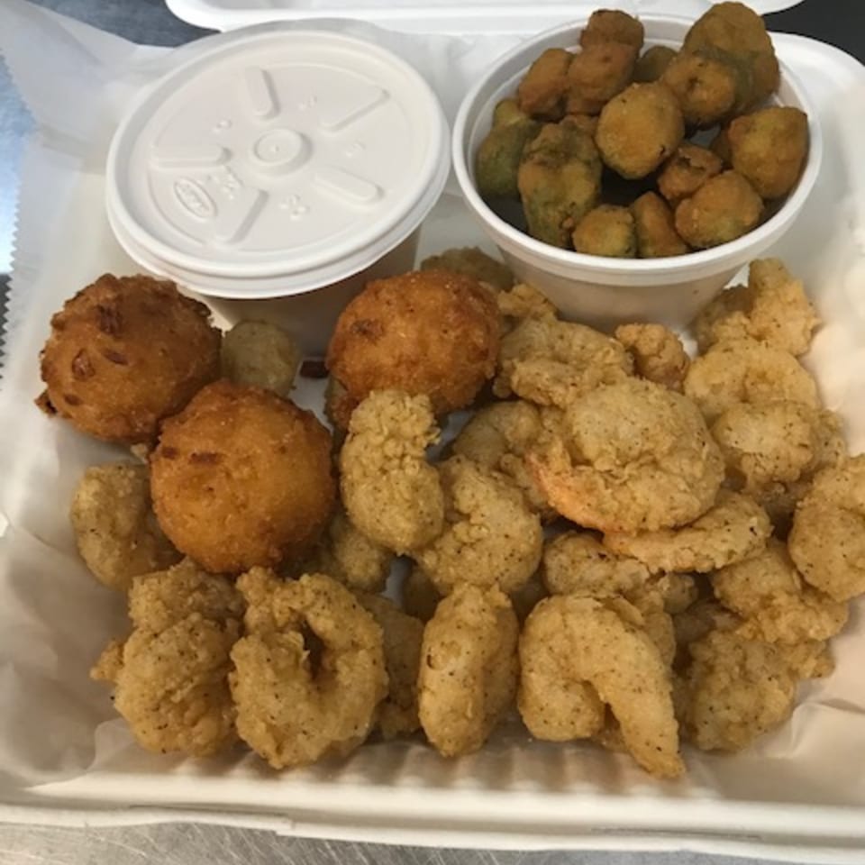 Fried shrimp, hushpuppies, and fried okra in a white takeout container from David's Catfish House.